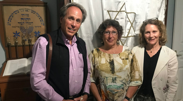 The author, Phyllis Dorey, with two others in front of the closed ark on erev Rosh HaShanah in Lisbon, Portugal